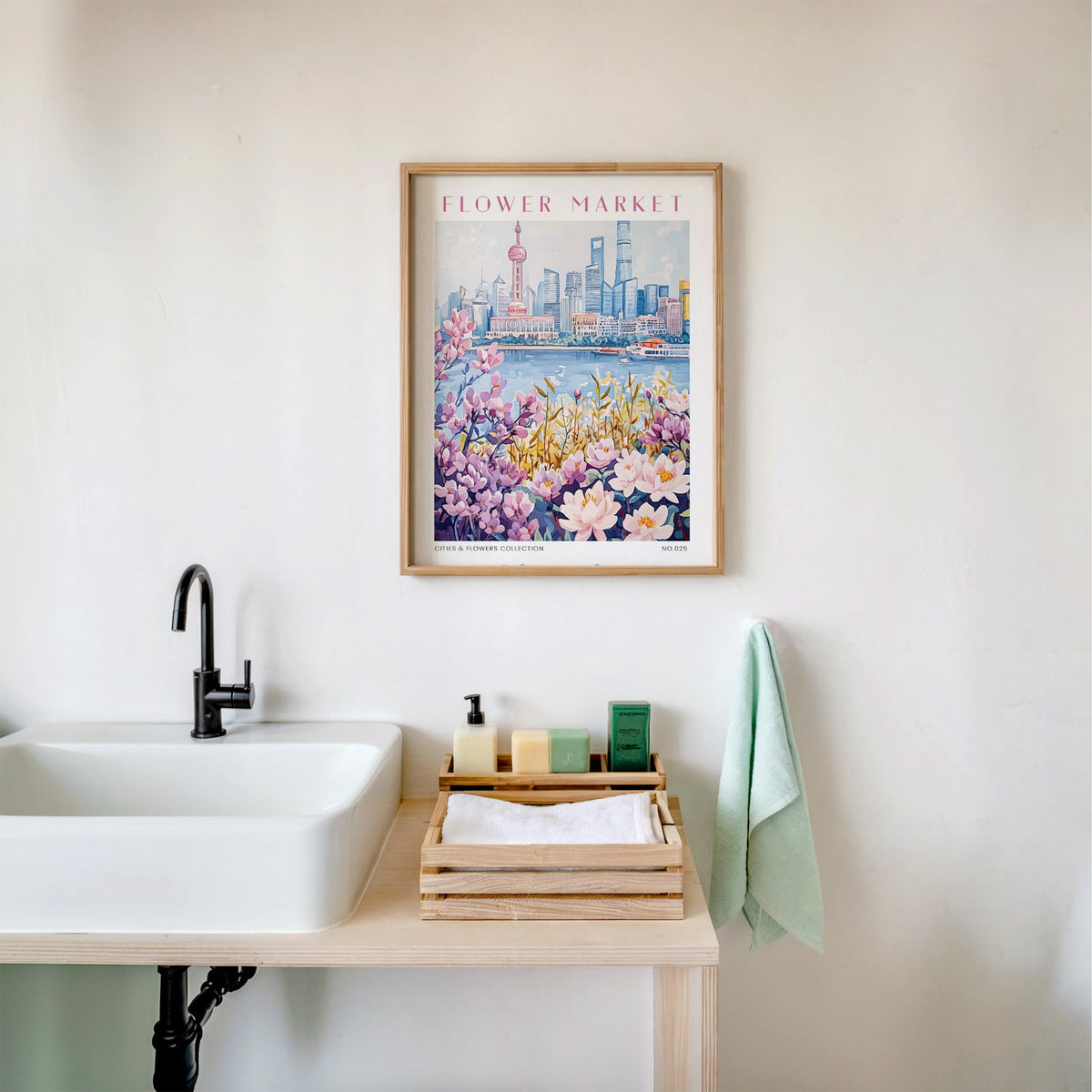 Shanghai flower market print in an oak frame above a white bathroom sink with folded towels