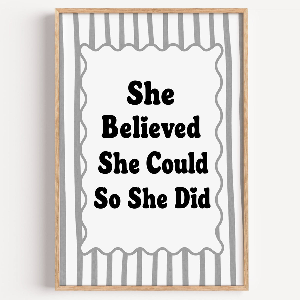 She believed she could so she did striped quote print in a light oak frame on a plain white wall