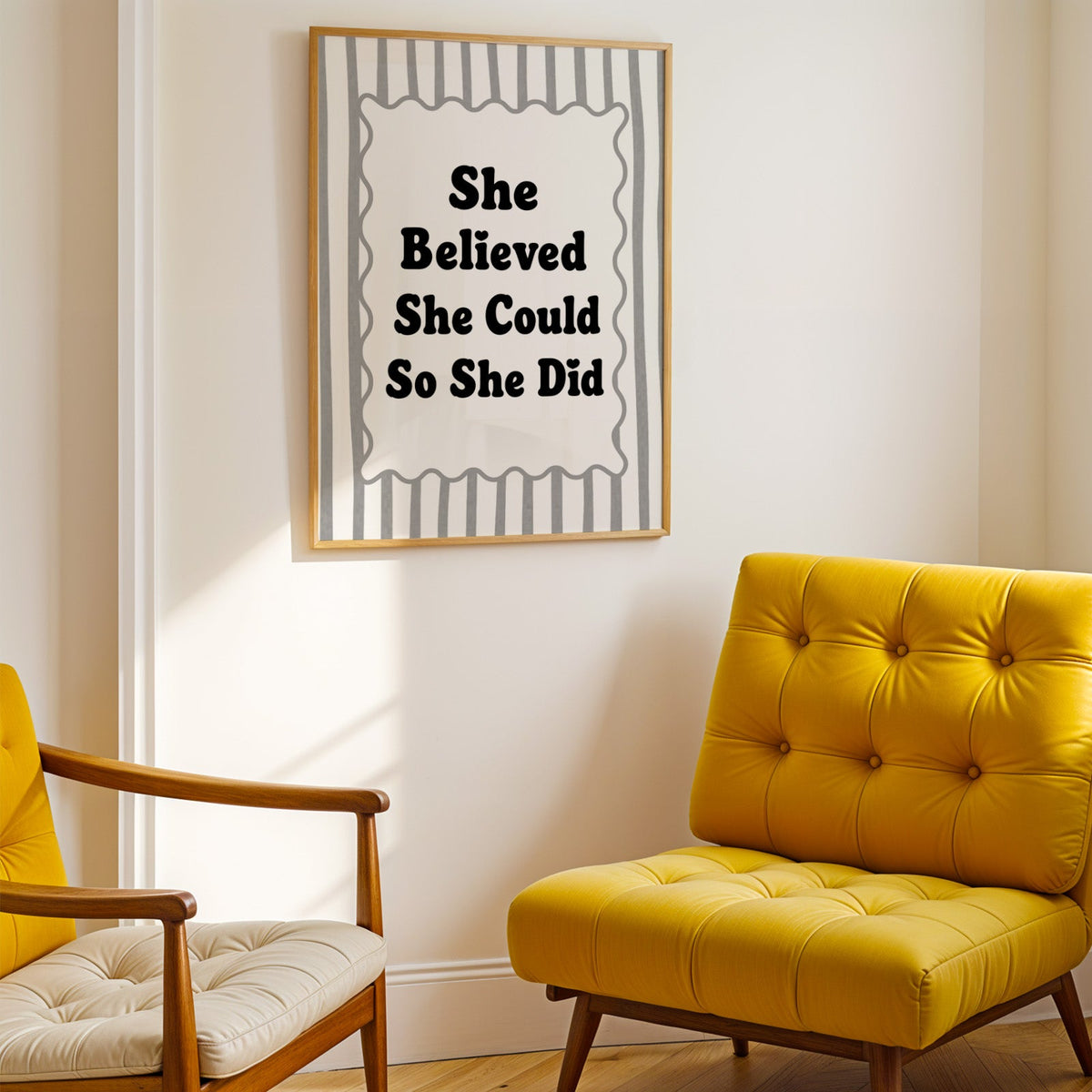 She believed she could so she did striped quote print shown in a gold frame above a mustard yellow tufted armchair