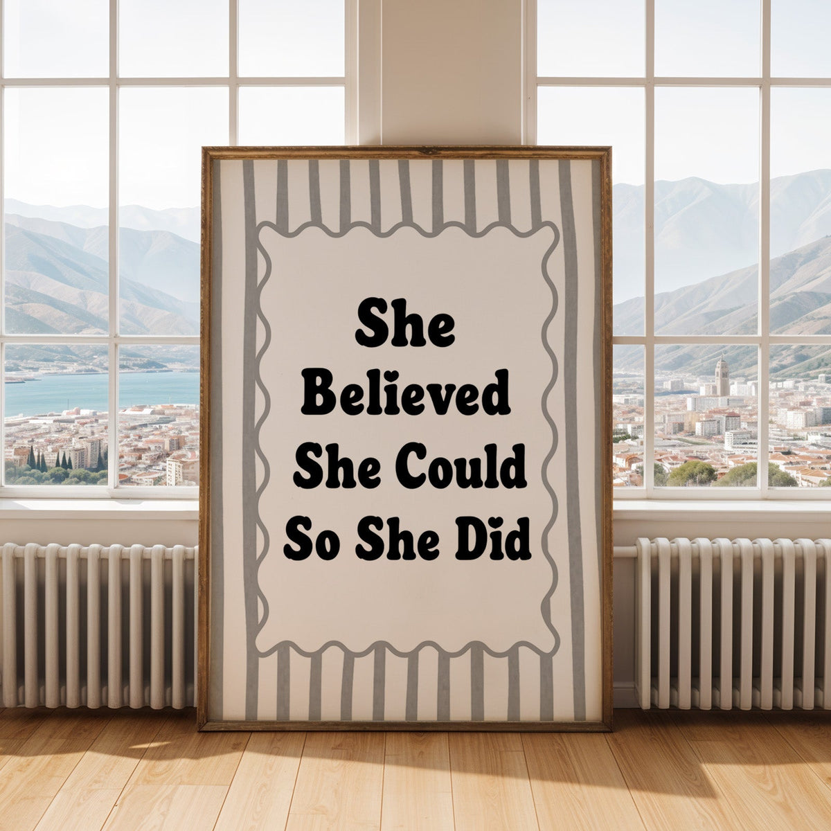 She believed she could so she did striped quote print shown in an antique gold frame by tall windows with a sea view