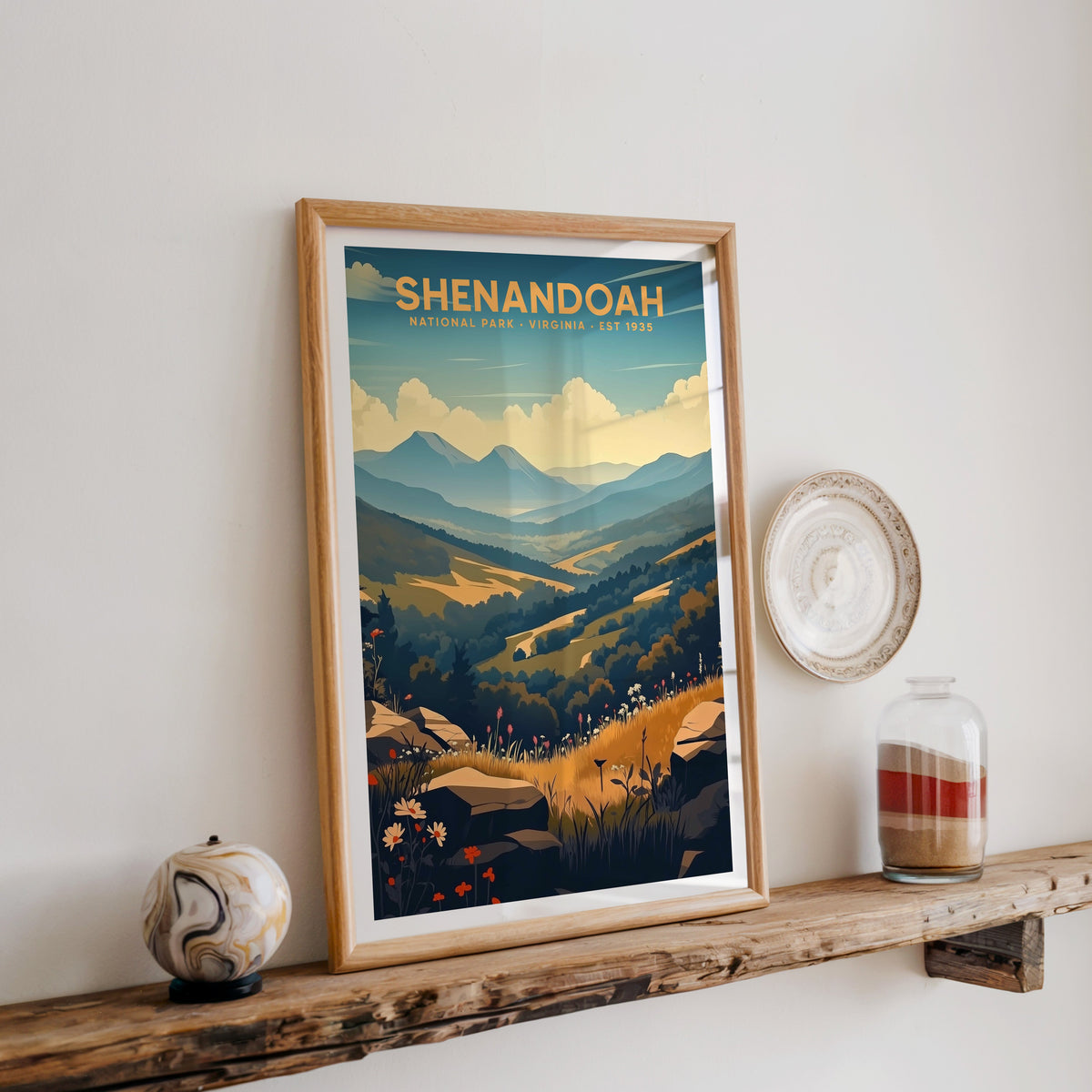 Shenandoah National Park print in an oak frame on a wood shelf with ceramics and a sand-filled jar