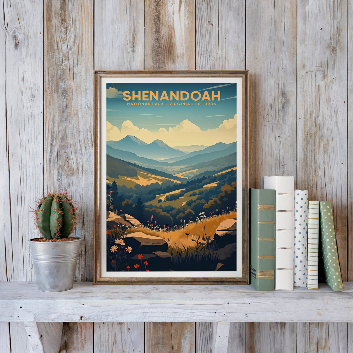 Shenandoah poster in an antique gold frame against whitewashed planks beside books and a cactus