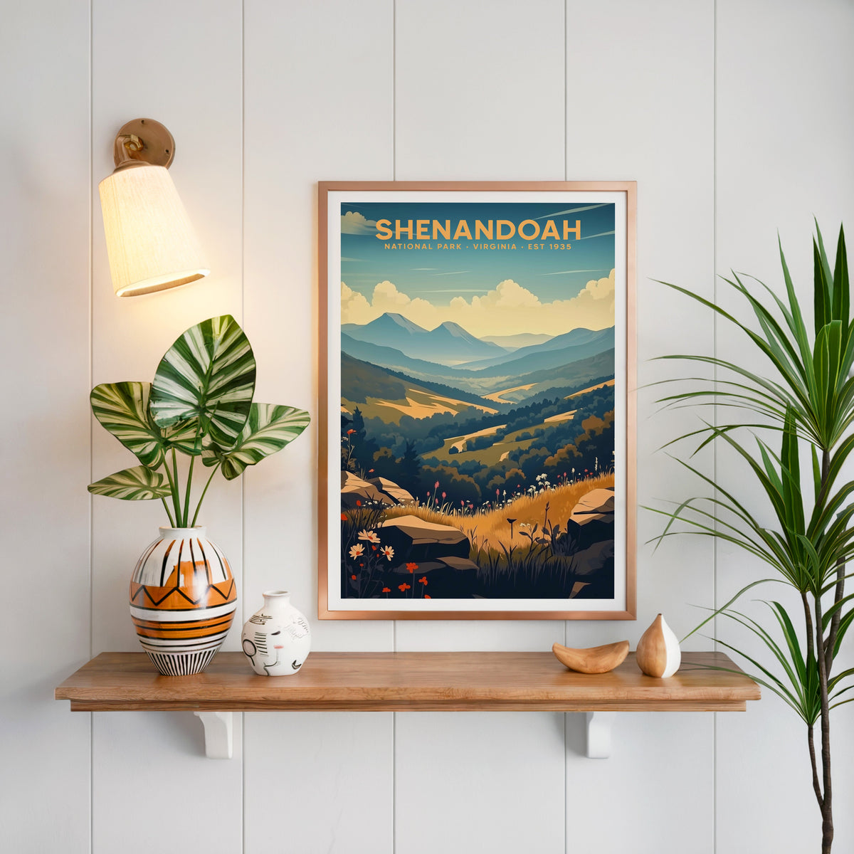 Shenandoah National Park print in a copper frame above an oak shelf on white shiplap with a brass sconce