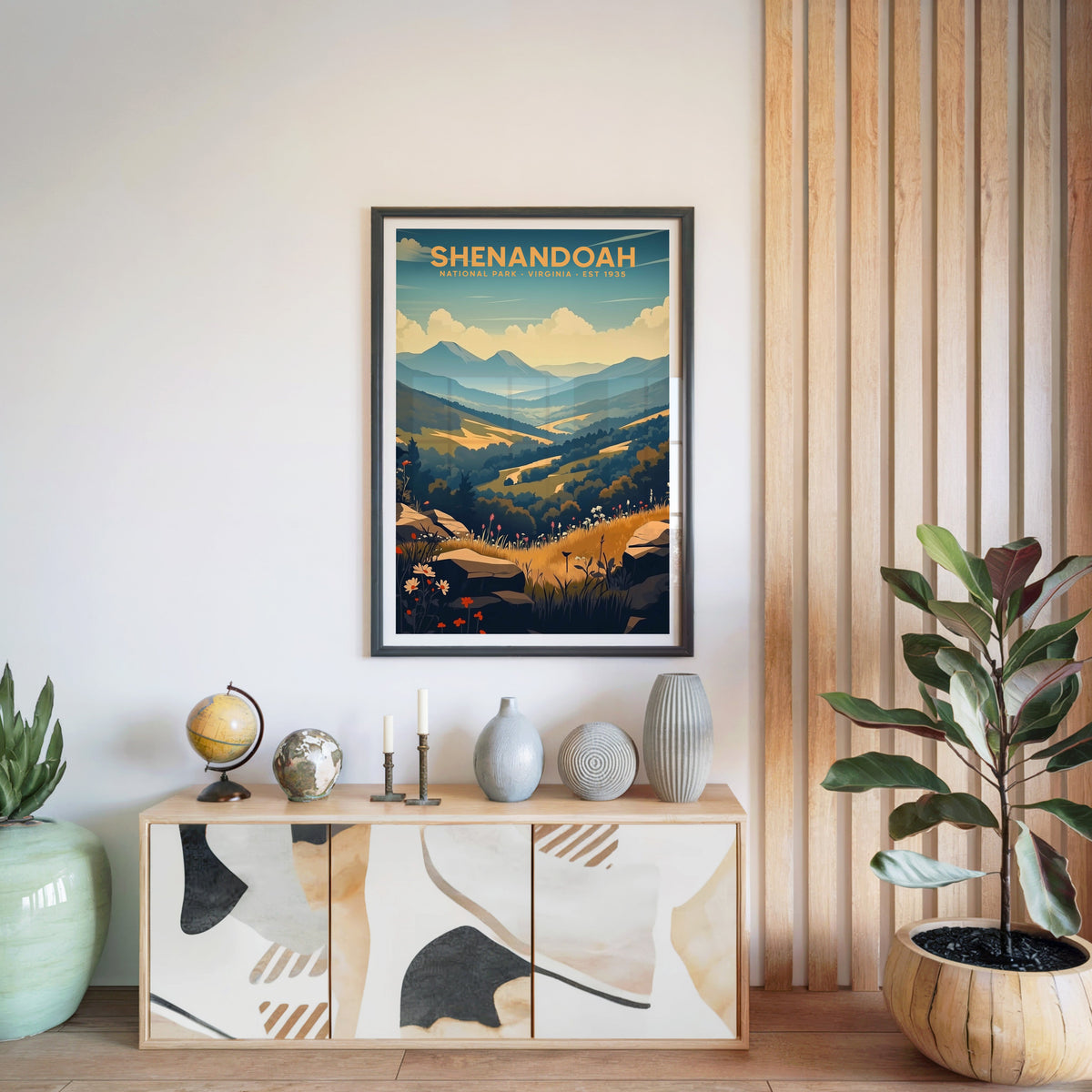 Shenandoah National Park print in a black frame above a light wood sideboard with a globe and ceramic vases