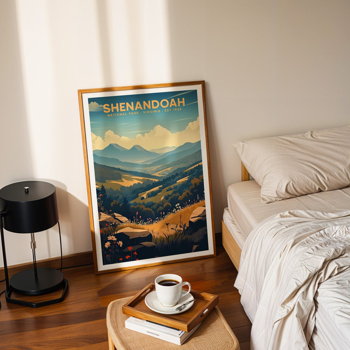 Shenandoah National Park print in an oak frame leaning on a bedroom floor beside the bed and a coffee tray