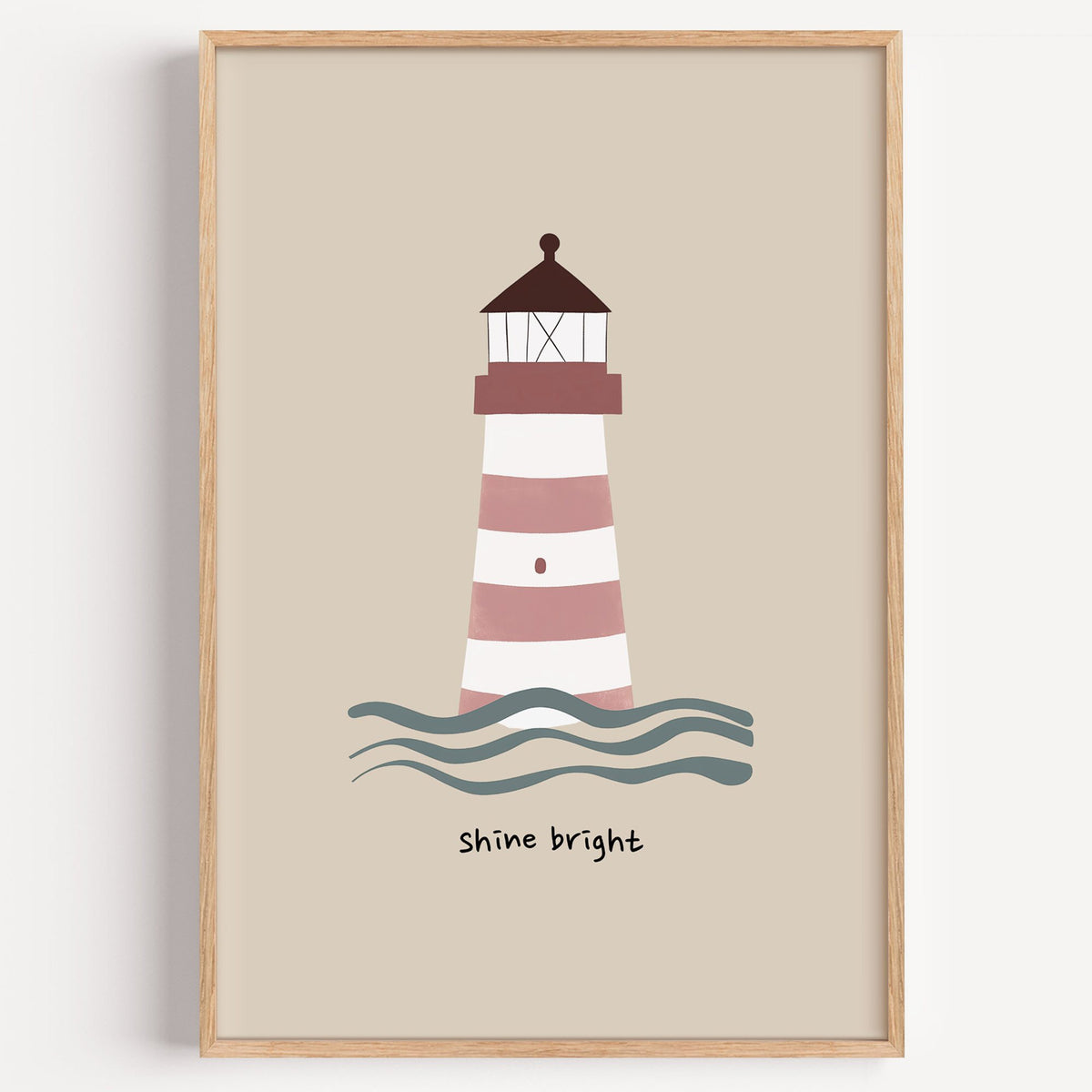 Shine bright lighthouse nursery print in a light oak frame on a plain white wall