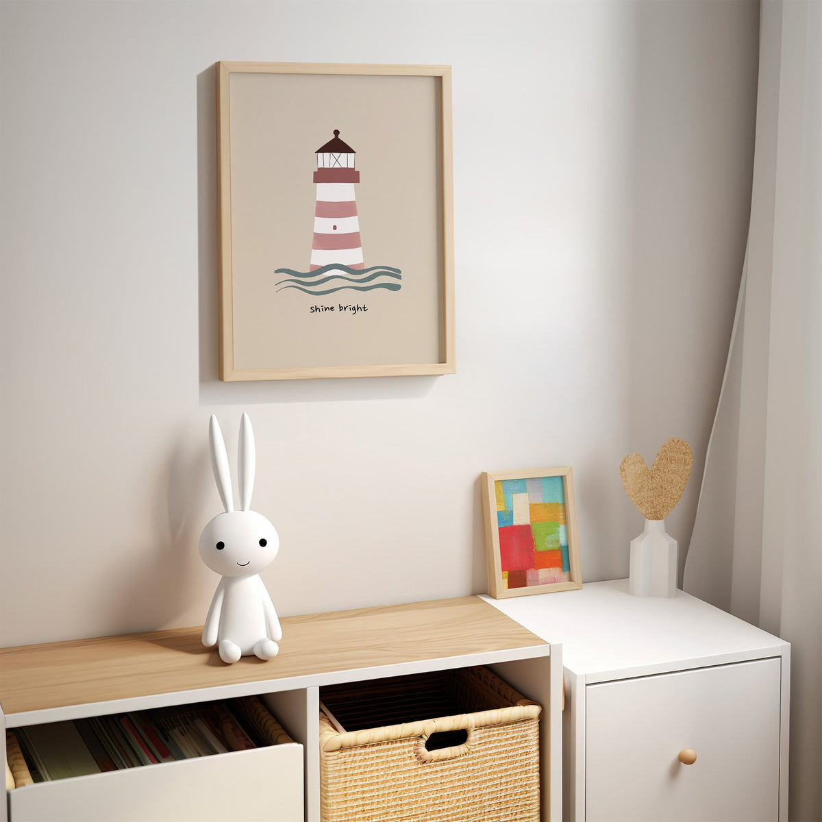 Shine bright lighthouse nursery print in an oak frame above a kids cubby shelf with a woven basket and bunny lamp