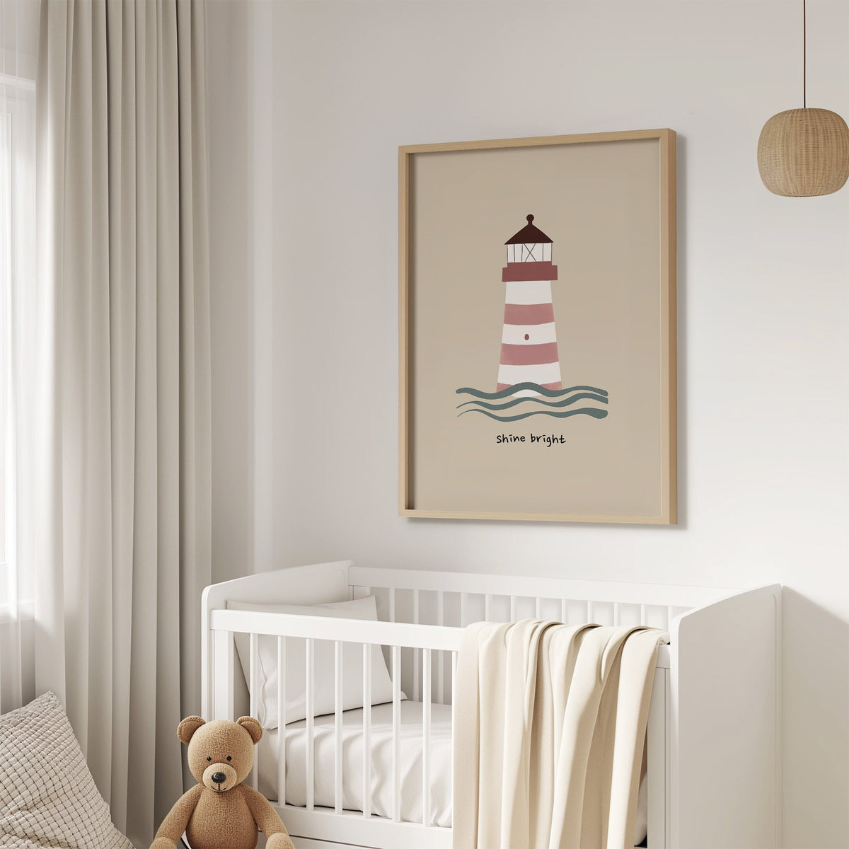 Shine bright lighthouse nursery print in an oak frame above a white crib with a teddy bear