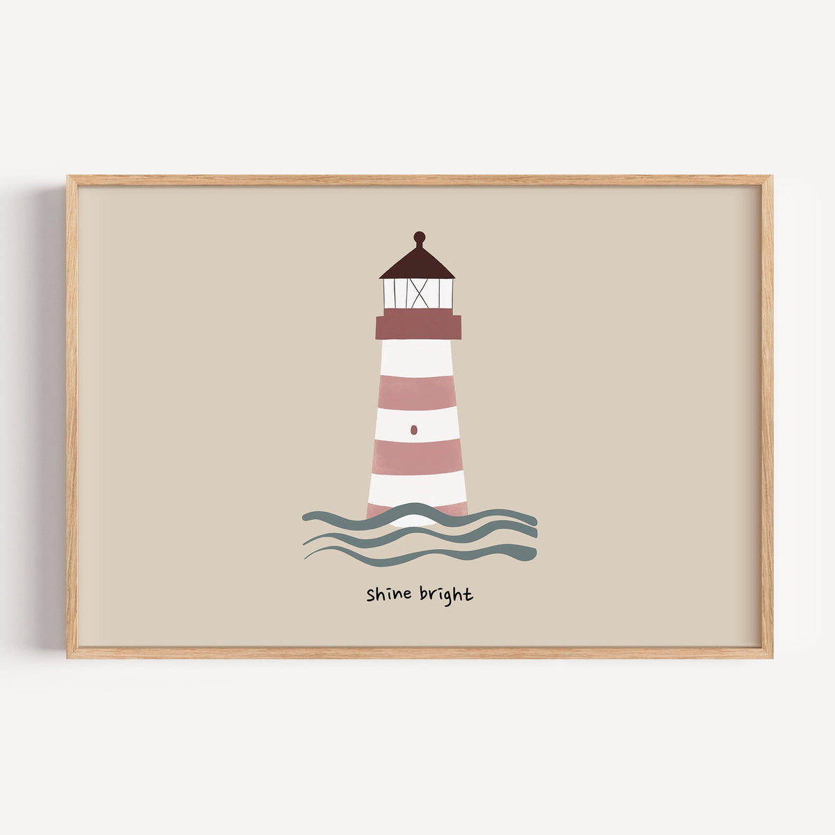 Landscape shine bright lighthouse nursery print in a light oak frame on a plain white wall