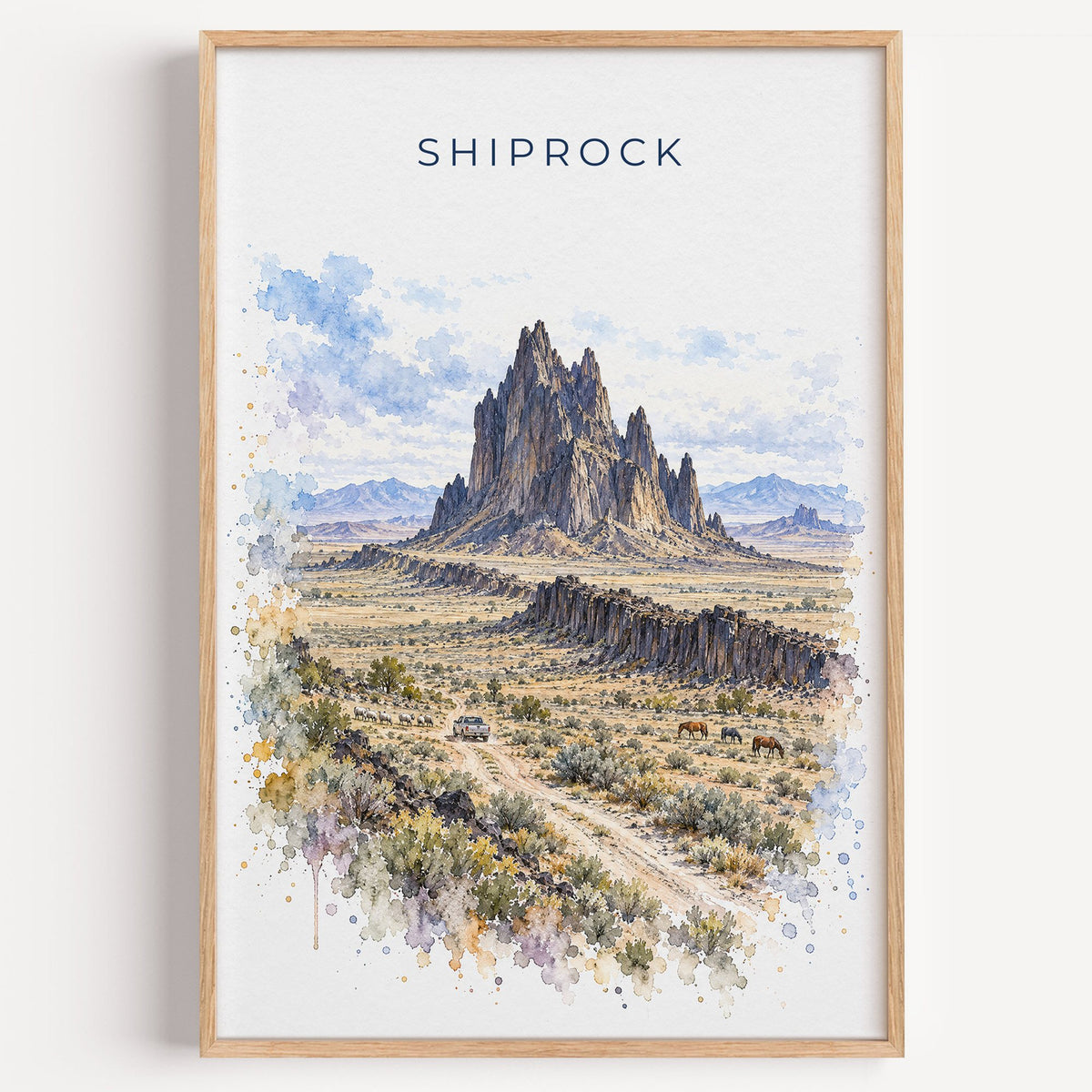 Shiprock watercolor print in a light oak frame on a plain white wall