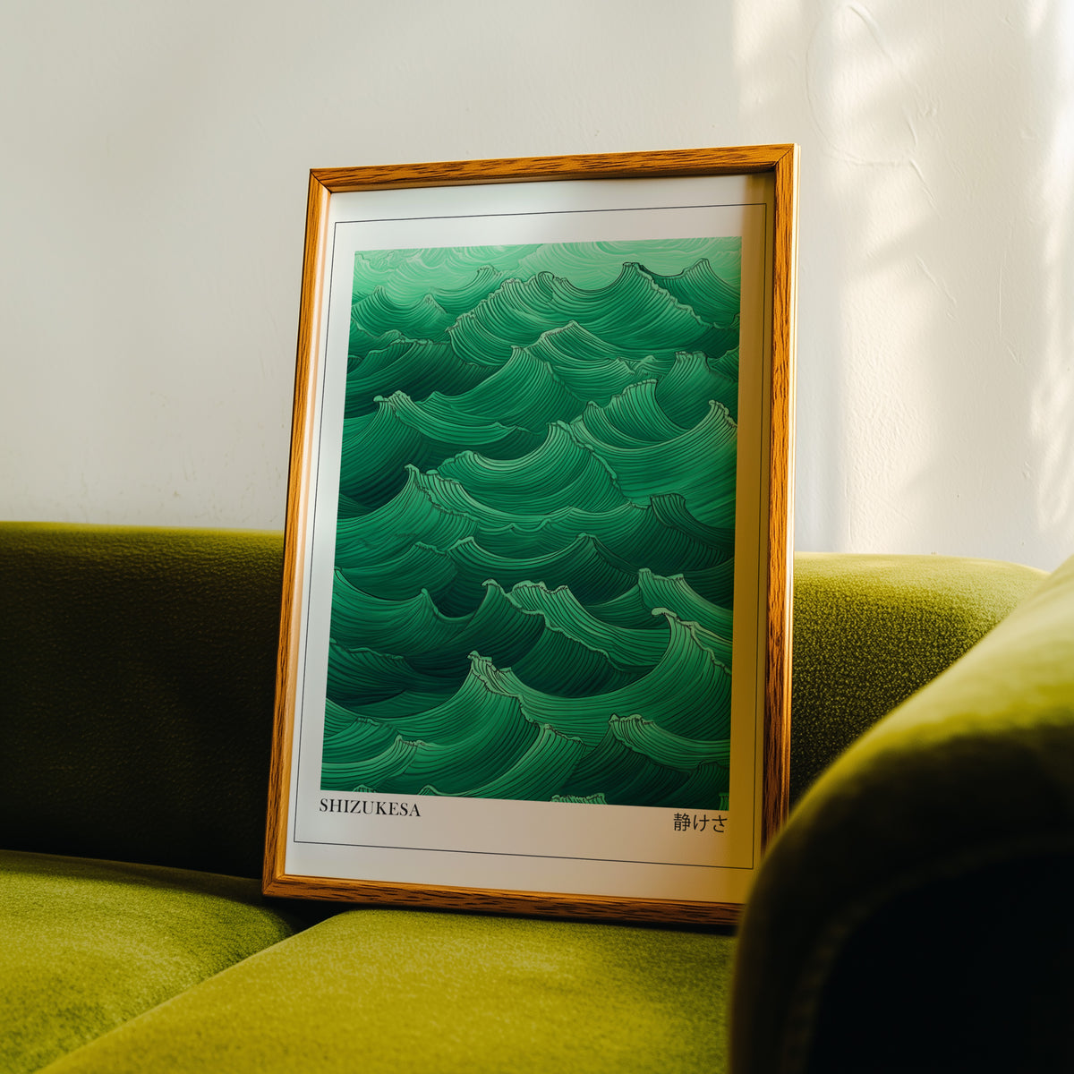 Jade green Shizukesa waves print in an oak frame propped on a green velvet sofa