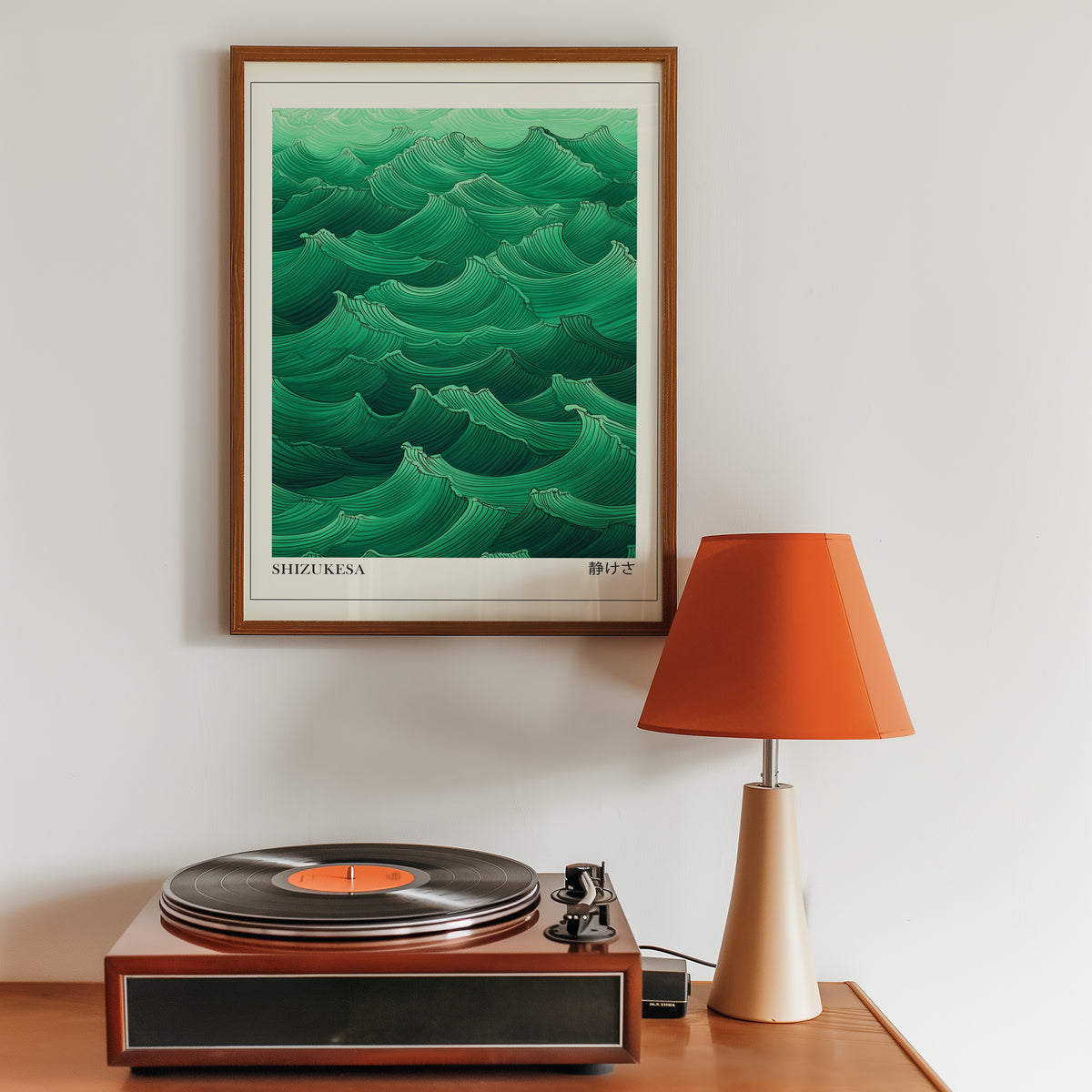 Jade green Shizukesa waves print in a walnut frame above a sideboard with a record player