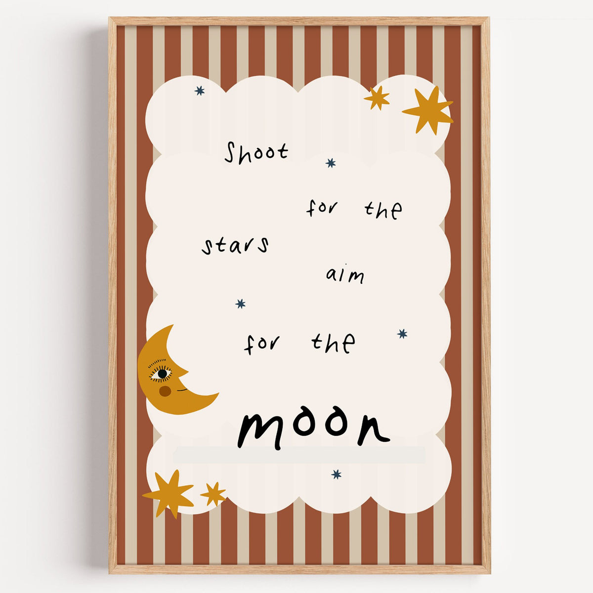 Shoot for the stars moon nursery print in a light oak frame on a plain white wall