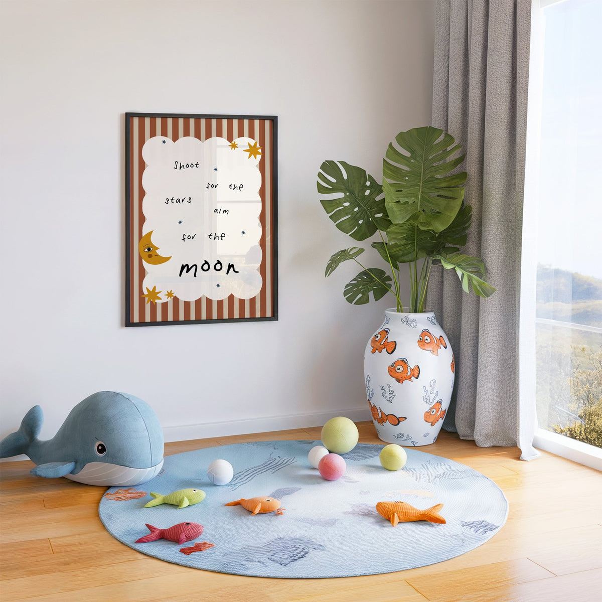 Shoot for the stars moon nursery print in a black frame in a playroom with an ocean rug and whale plush