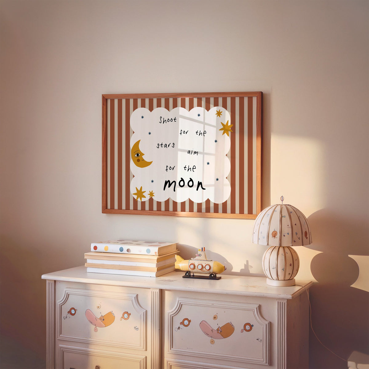 Landscape shoot for the stars moon nursery print in a cherry wood frame above a painted dresser and lamp