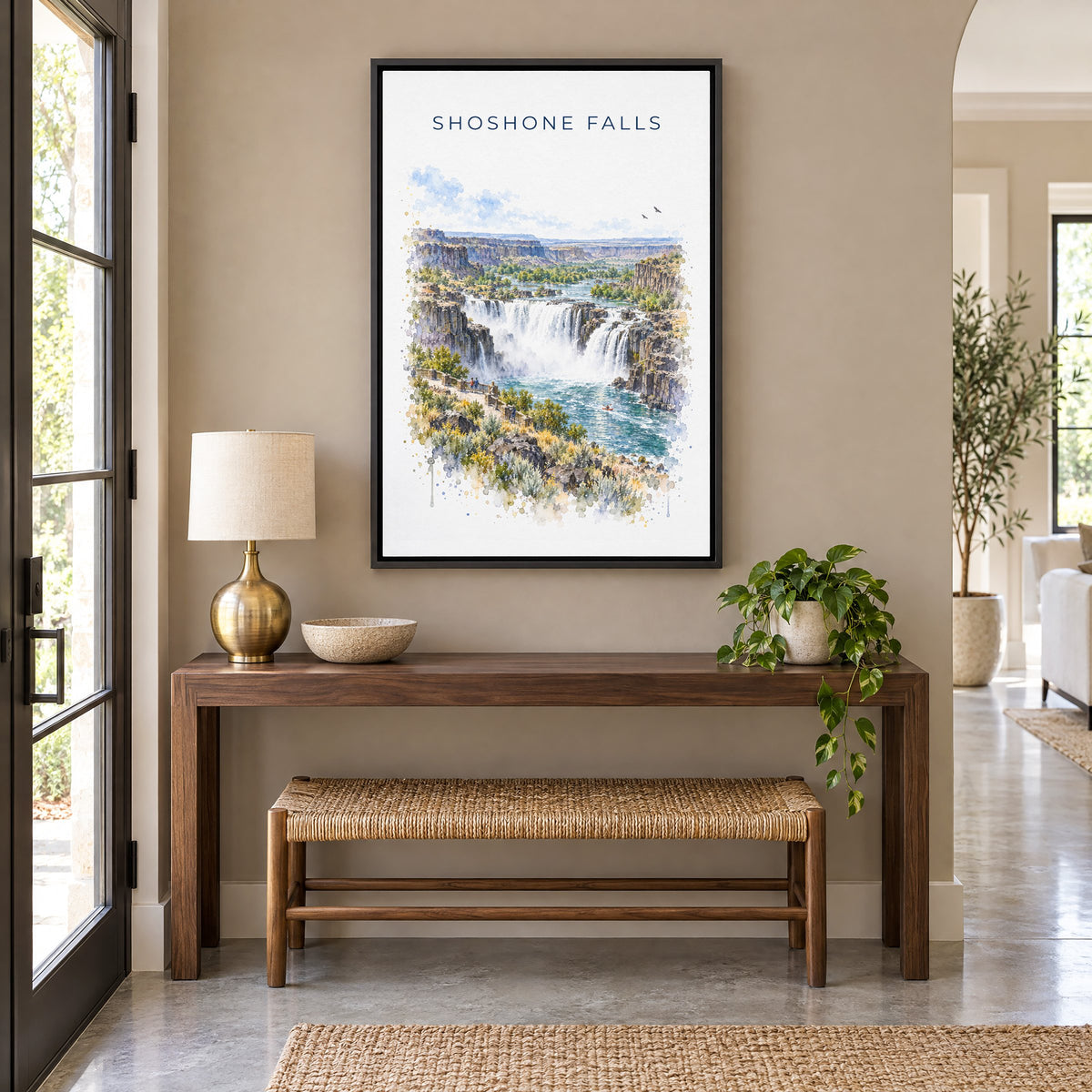 Shoshone Falls watercolor print as a black floater canvas above a walnut console and woven bench in an entryway