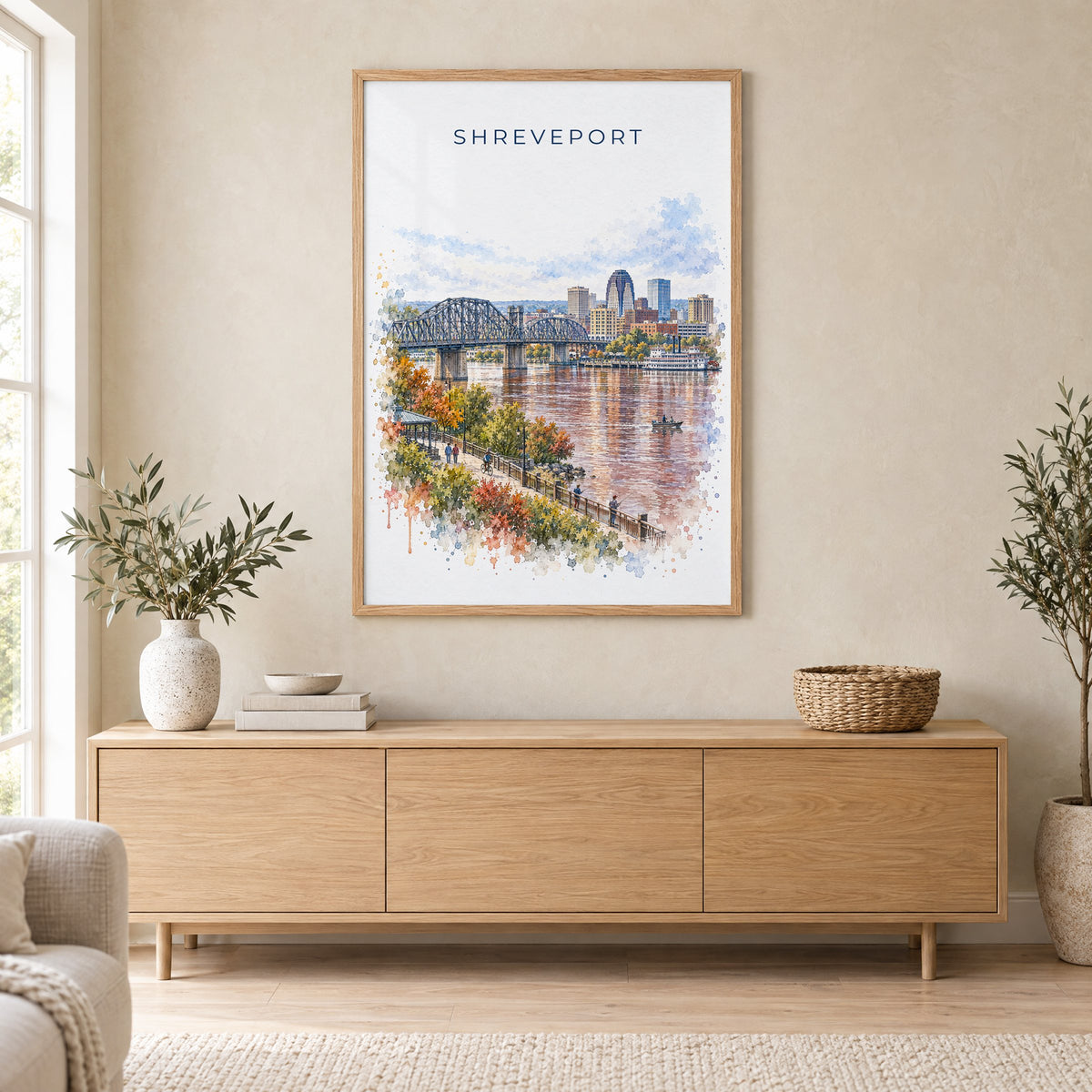 Shreveport watercolor print in an oak frame above a light wood sideboard in a Scandinavian living room