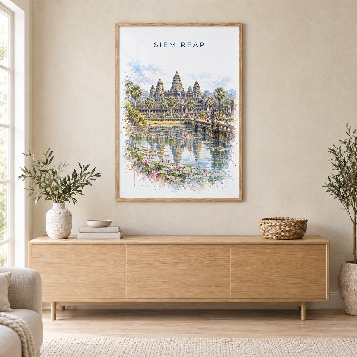 Siem Reap watercolor print in an oak frame above a light wood sideboard in a Scandinavian living room