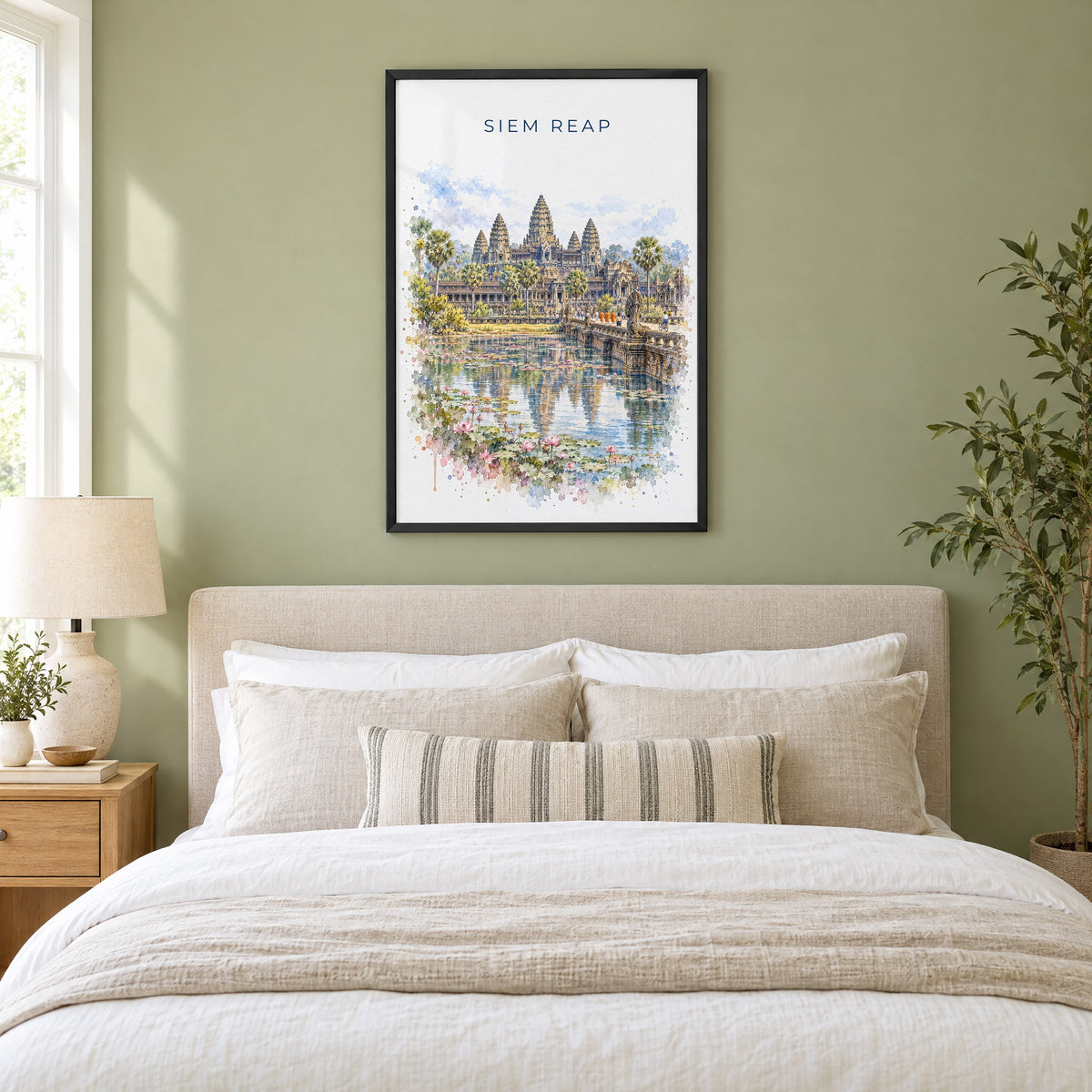 Siem Reap watercolor print in a black frame above an upholstered headboard in a sage green bedroom