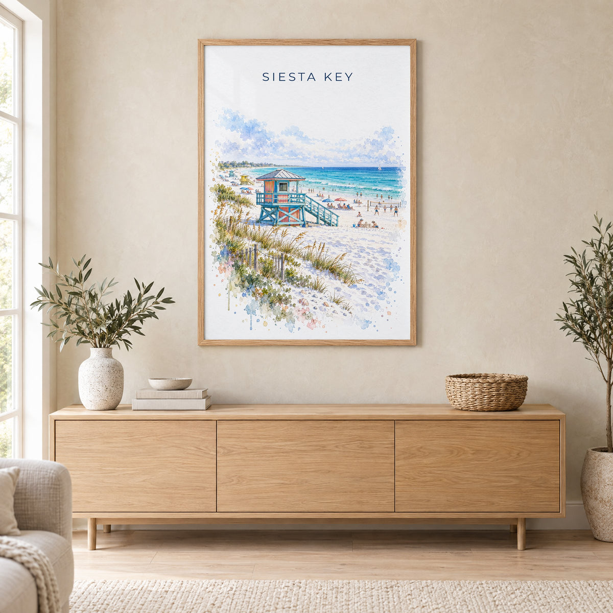 Siesta Key watercolor print in an oak frame above a light wood sideboard in a Scandinavian living room