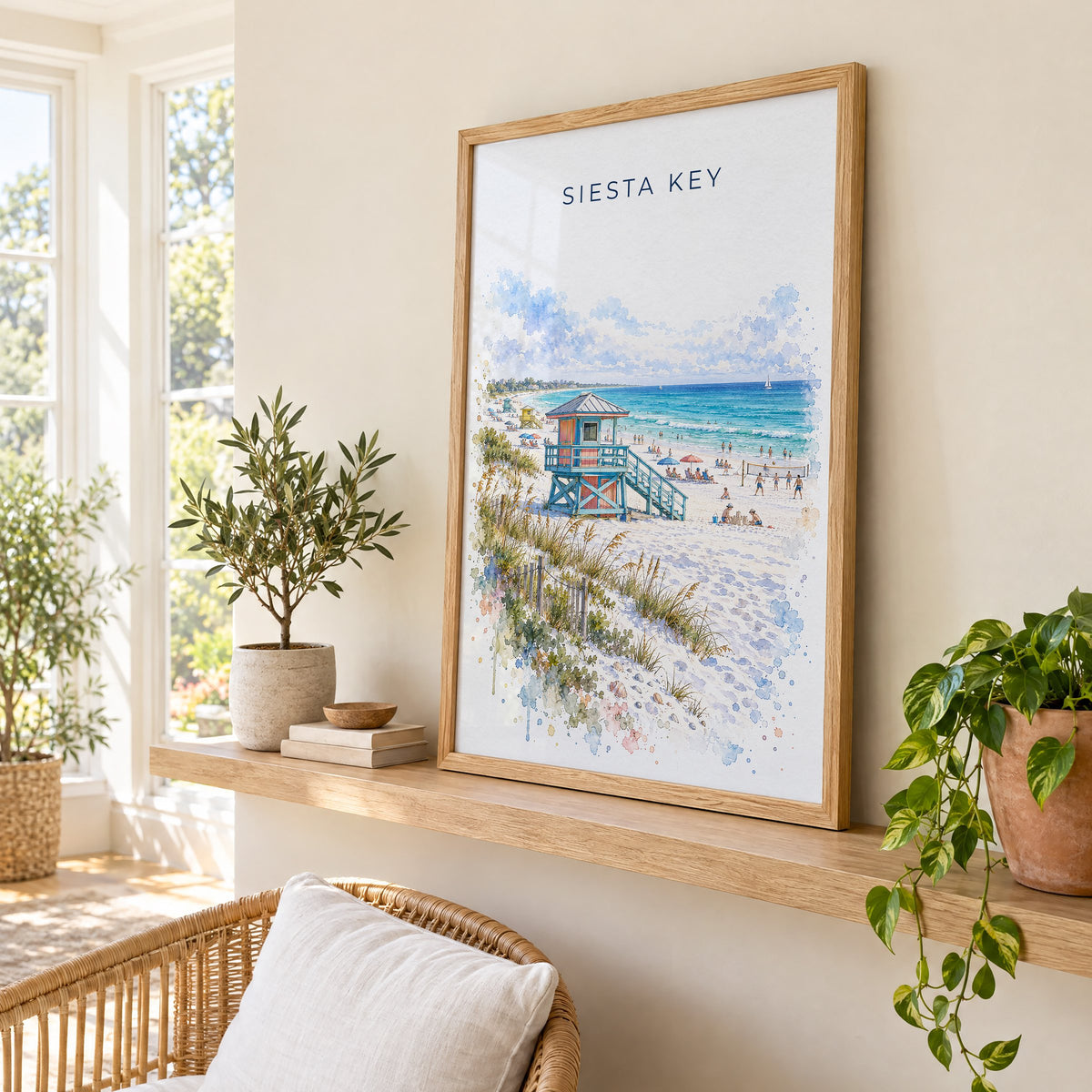 Siesta Key watercolor print in an oak frame on a picture ledge in a sunlit sunroom
