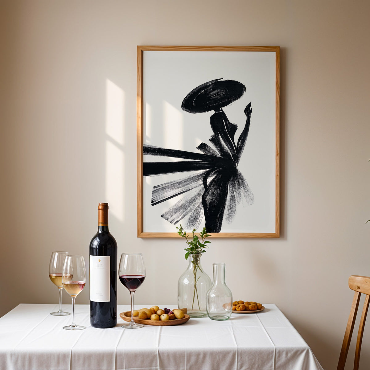 Woman in wide hat with fanned brushstroke skirt print in an oak frame above a table set with red wine and glasses