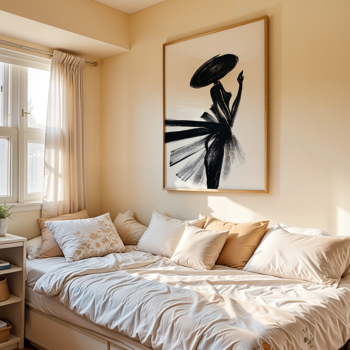 Woman in wide hat with fanned brushstroke skirt print in an oak frame above a cream daybed in a sunny bedroom