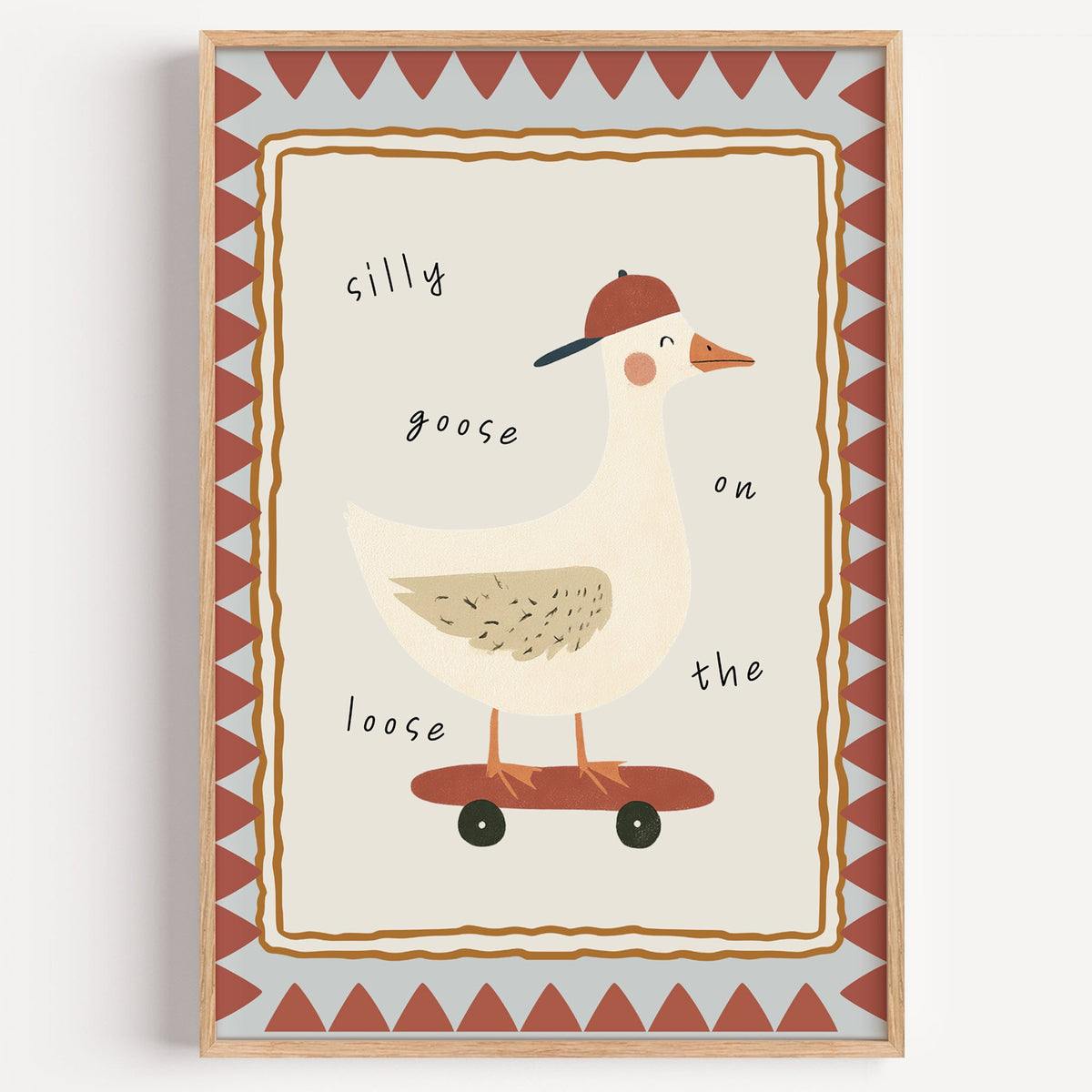 Silly goose on the loose nursery print in a light oak frame on a plain white wall