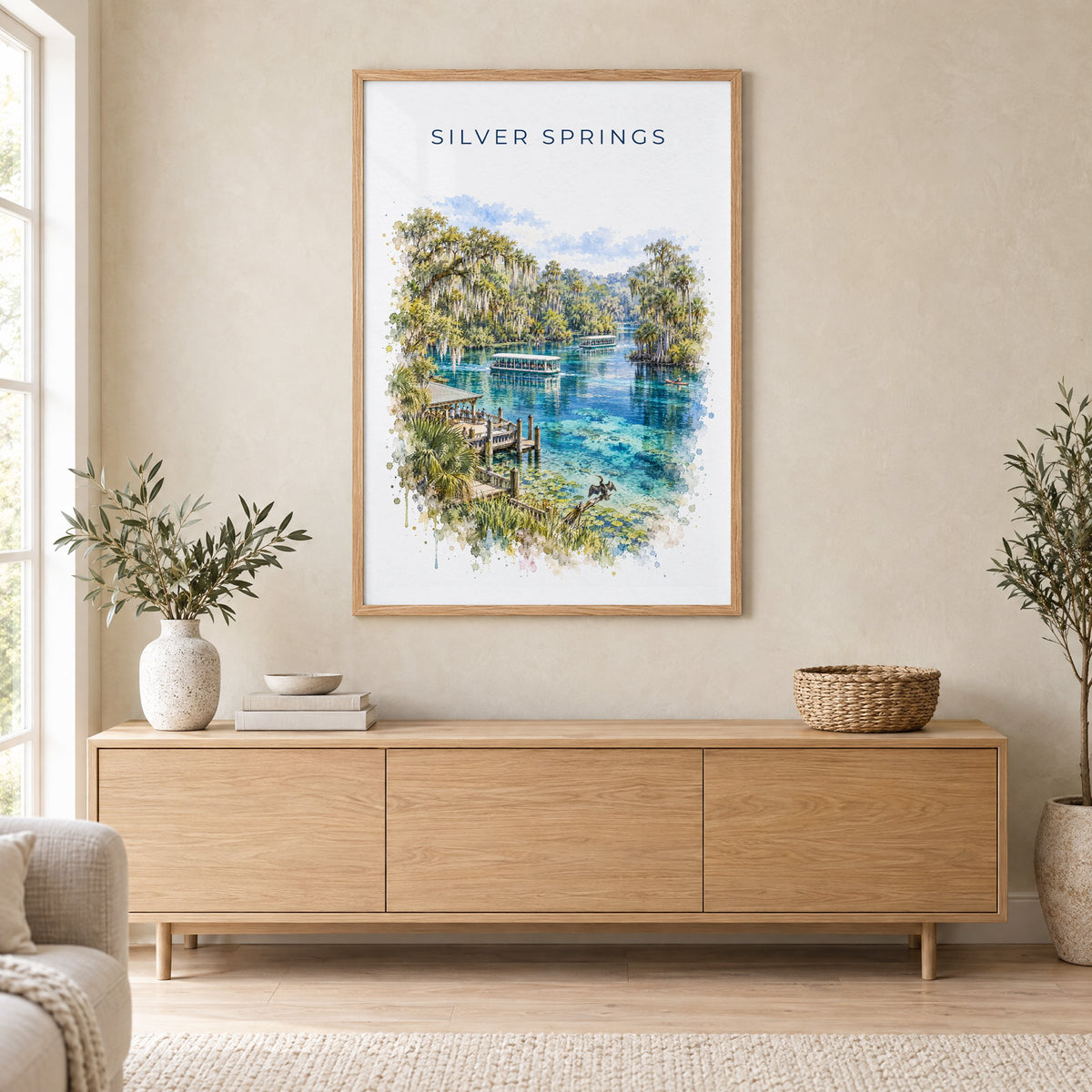 Silver Springs State Park watercolor print in an oak frame above a light wood sideboard in a Scandinavian living room