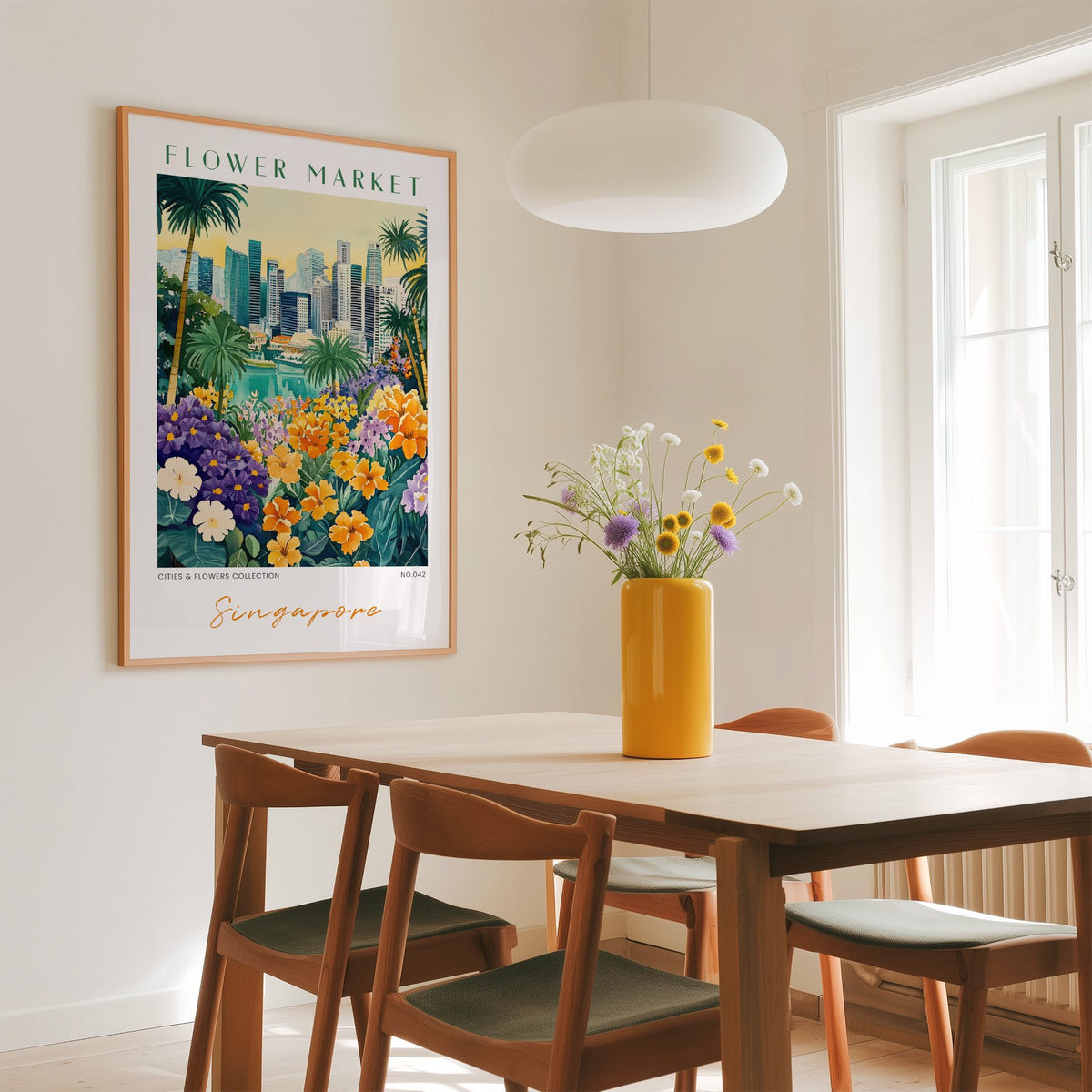 Singapore flower market print in an oak frame above a dining table with a yellow vase and white pendant light