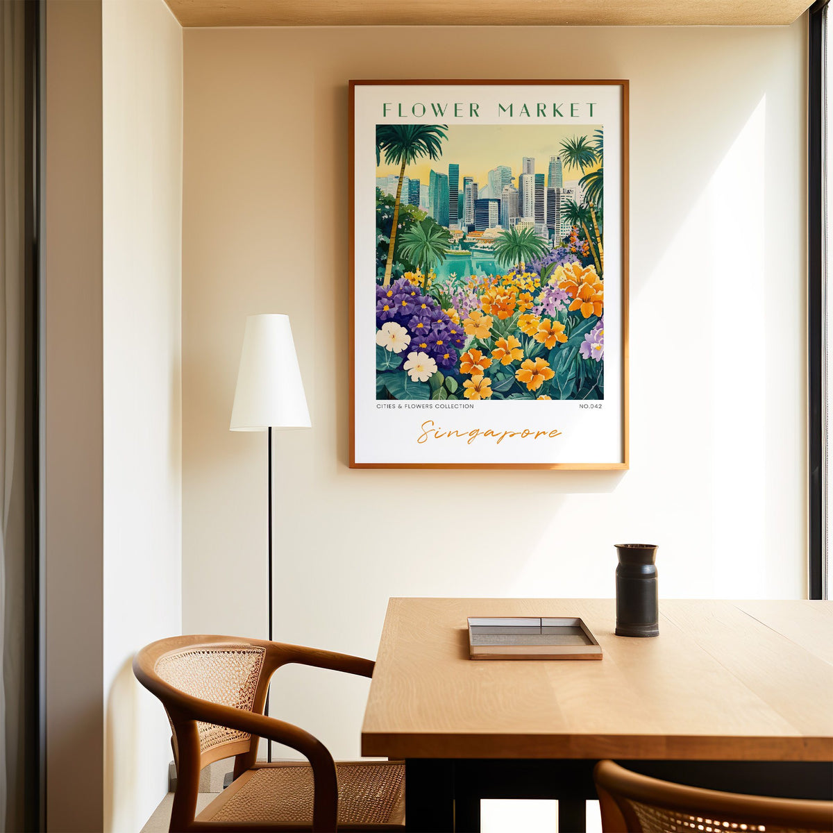 Singapore flower market print in an oak frame above a dining table and cane chair