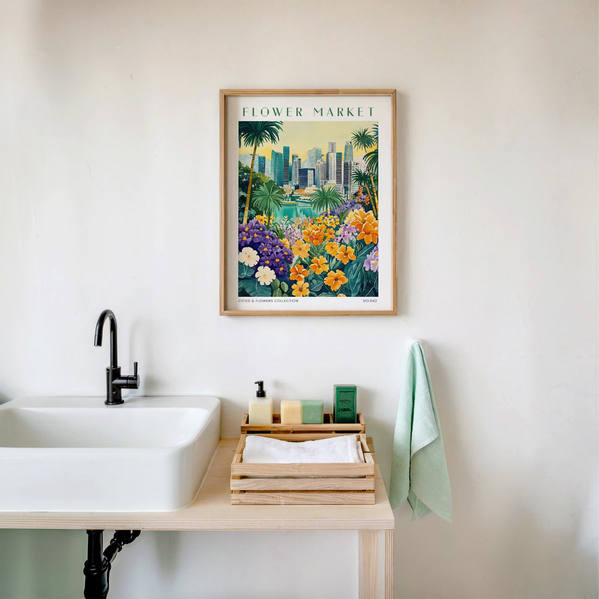 Singapore flower market print in an oak frame above a white bathroom sink with folded towels