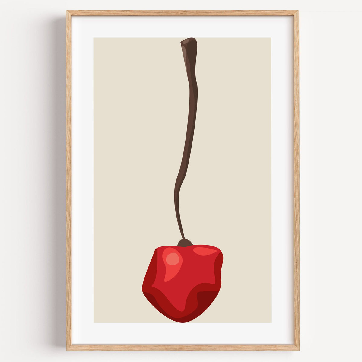Single red cherry long stem minimalist print in a light oak frame on a plain white wall