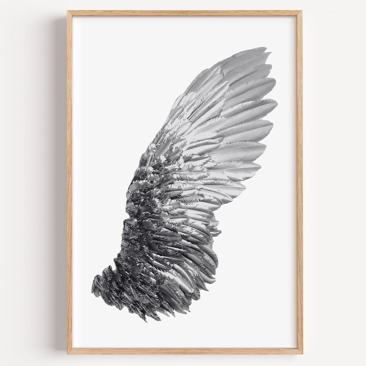 Single silver metallic wing on white print in a light oak frame on a plain white wall