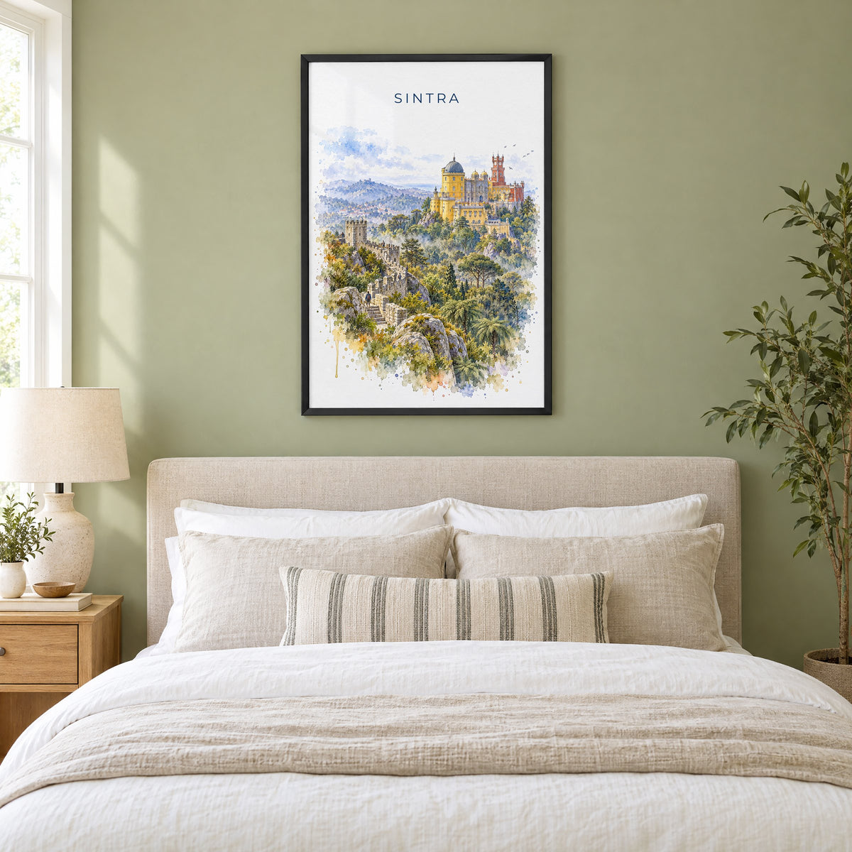 Sintra watercolor print in a black frame above an upholstered headboard in a sage green bedroom