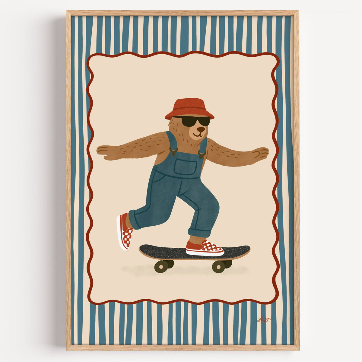 Bear in overalls on a skateboard nursery print in a light oak frame on a plain white wall