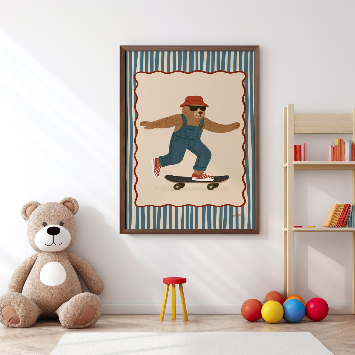 Bear in overalls on a skateboard nursery print in a walnut frame above a big teddy bear by a bookshelf