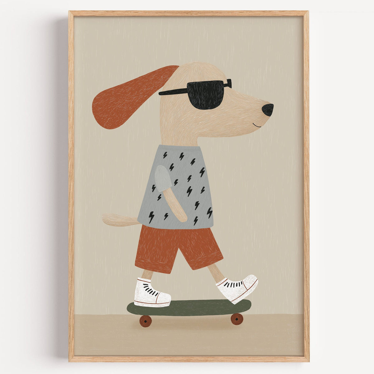 Skateboard dog lightning tee nursery print in a light oak frame on a plain white wall
