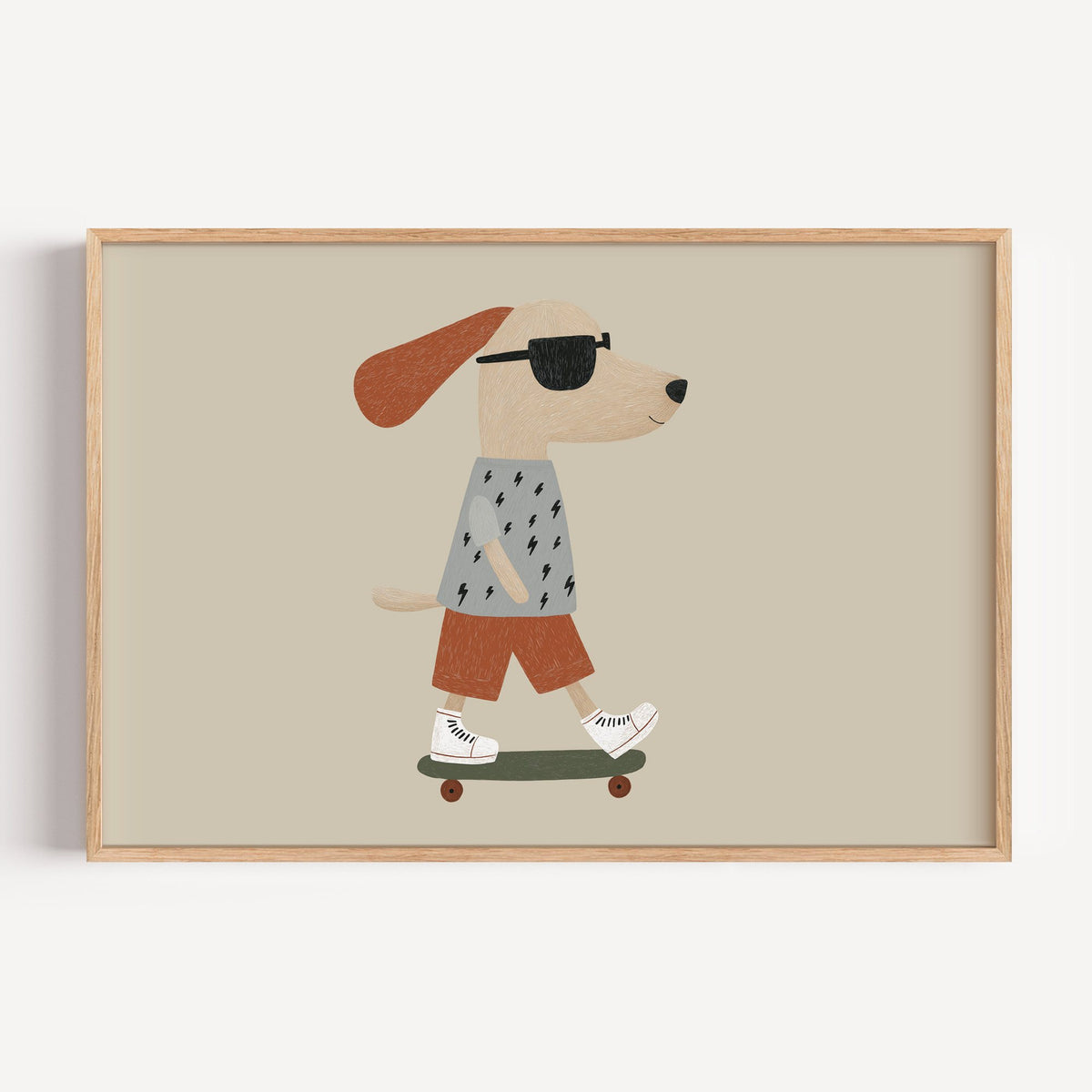 Landscape skateboard dog lightning tee nursery print in a light oak frame on a plain white wall