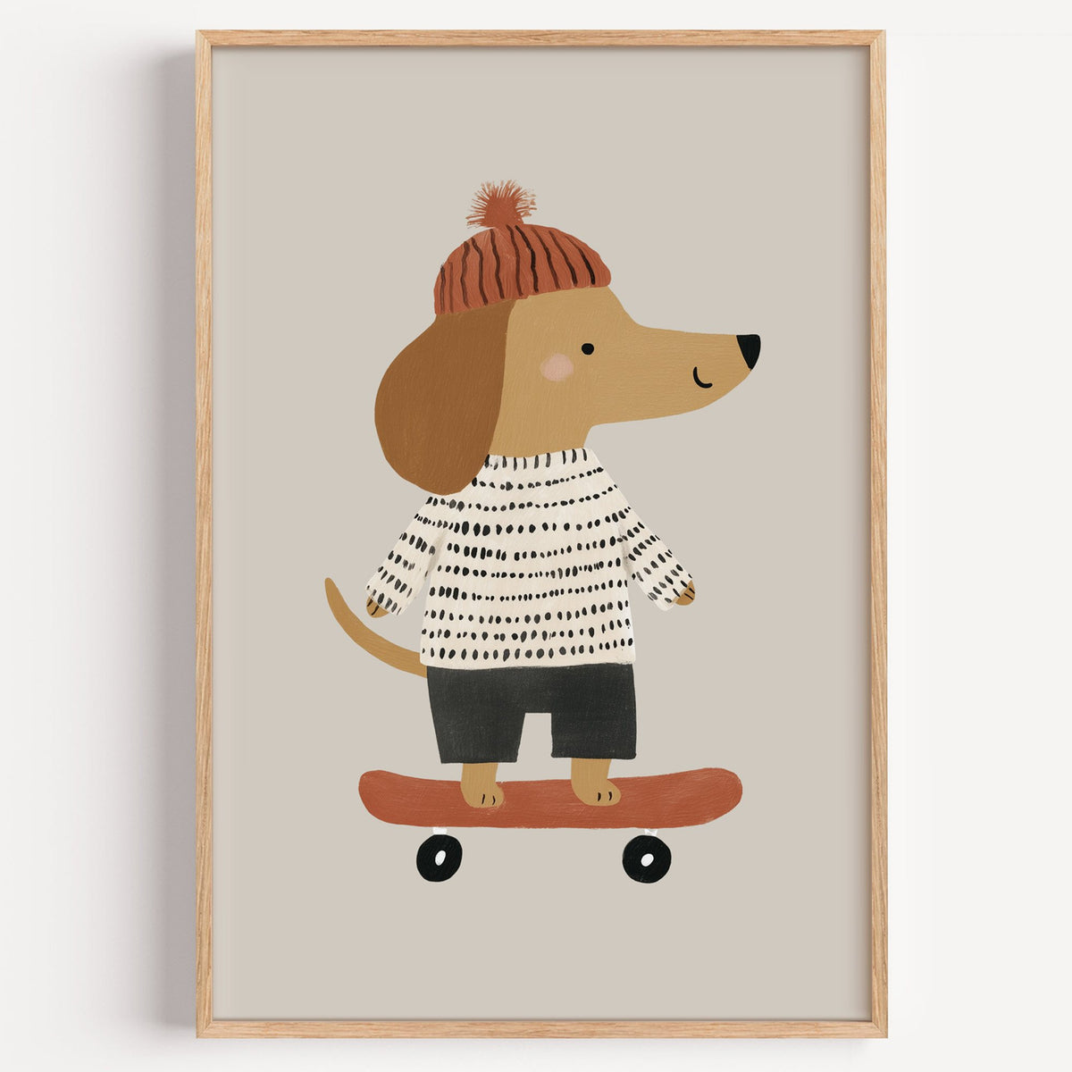 Skateboard dog pompom beanie nursery print in a light oak frame on a plain white wall