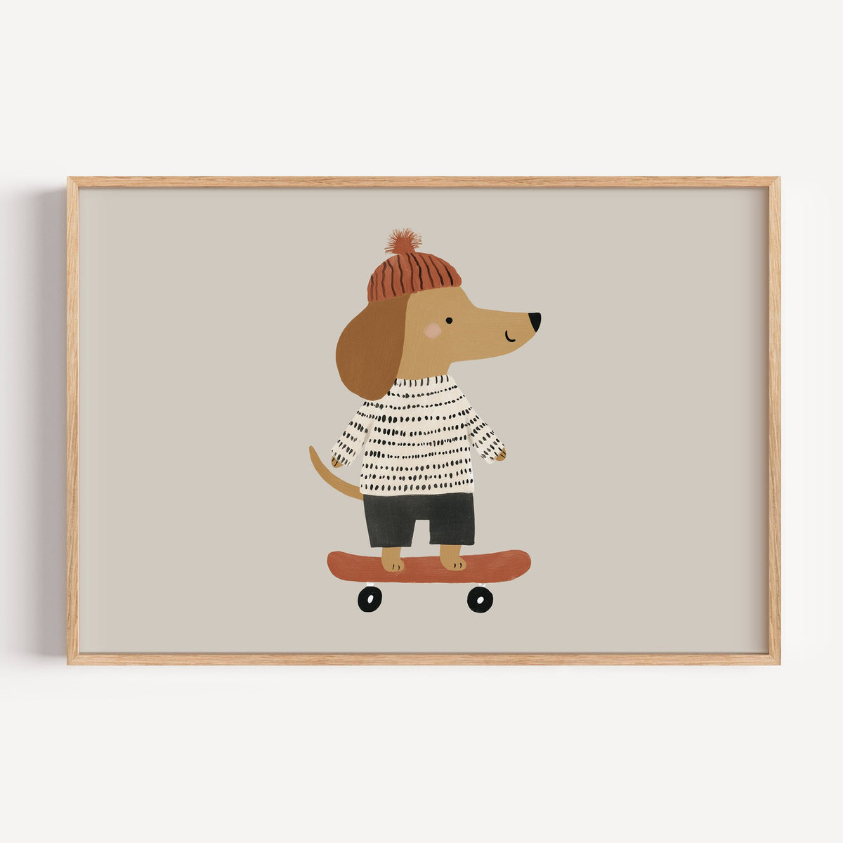 Landscape skateboard dog pompom beanie nursery print in a light oak frame on a plain white wall