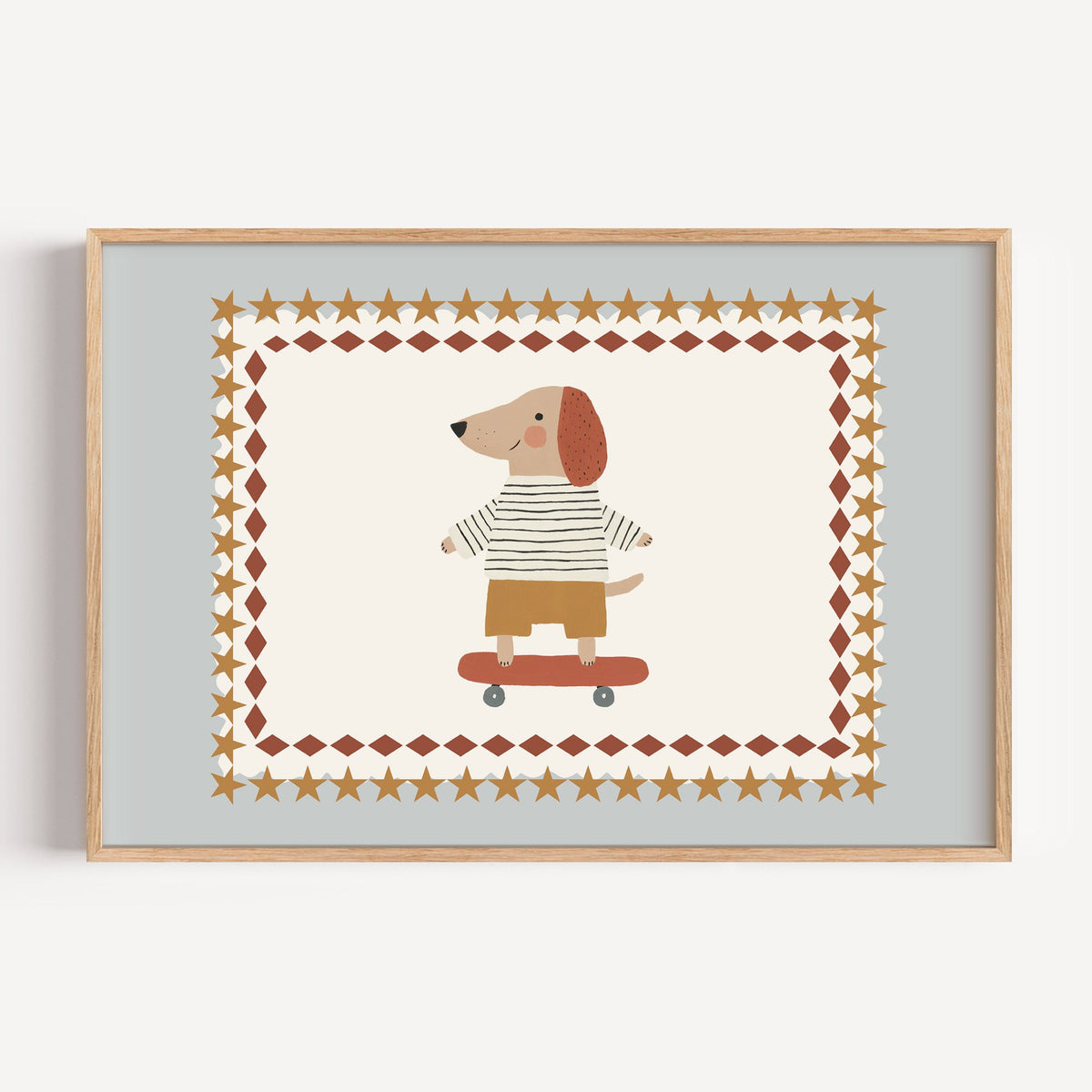 Landscape skateboard dog star frame nursery print in a light oak frame on a plain white wall