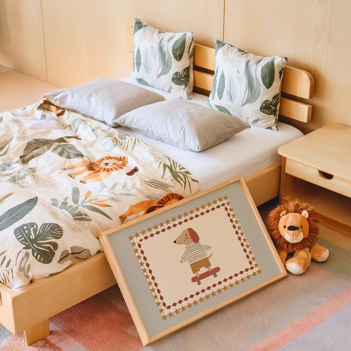 Landscape skateboard dog star frame nursery print in an oak frame leaning on a kids bed by a lion plush