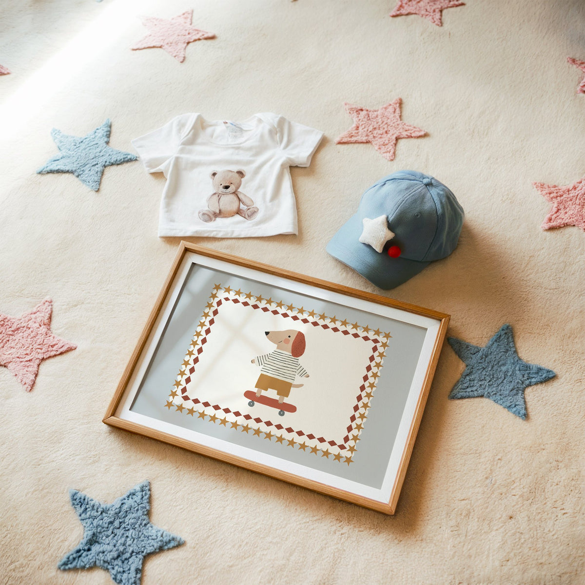 Landscape skateboard dog star frame nursery print in a matted oak frame on a star rug with a baby tee