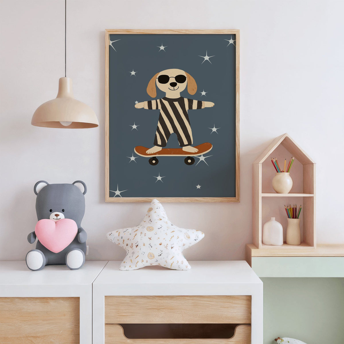 Skateboard dog starry night nursery print in an oak frame above a white dresser with a star pillow and house shelf