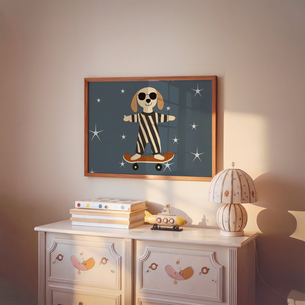 Landscape skateboard dog starry night nursery print in a cherry wood frame above a painted dresser and lamp