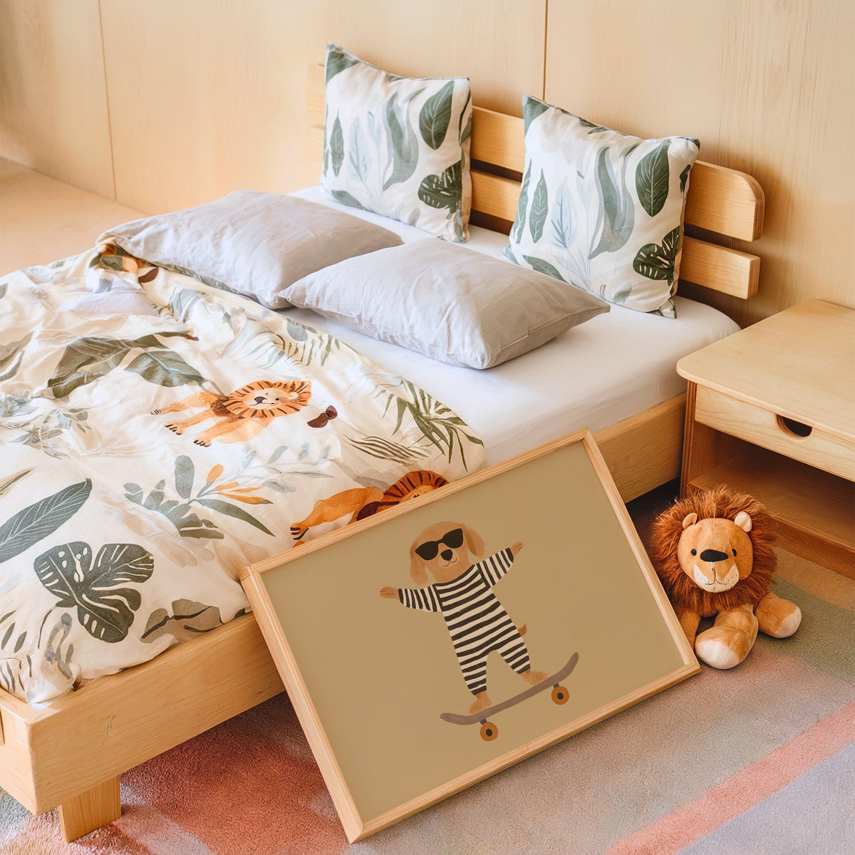 Landscape skateboard dog striped onesie nursery print in an oak frame leaning on a kids bed by a lion plush