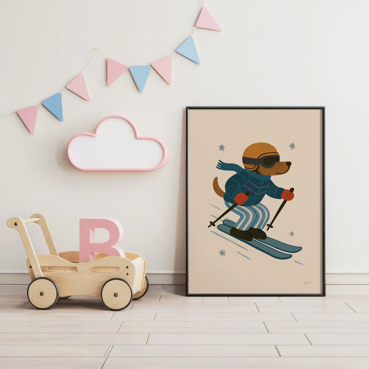 Skiing dog in puffer jacket nursery print in a black frame under pastel bunting by a wooden baby walker
