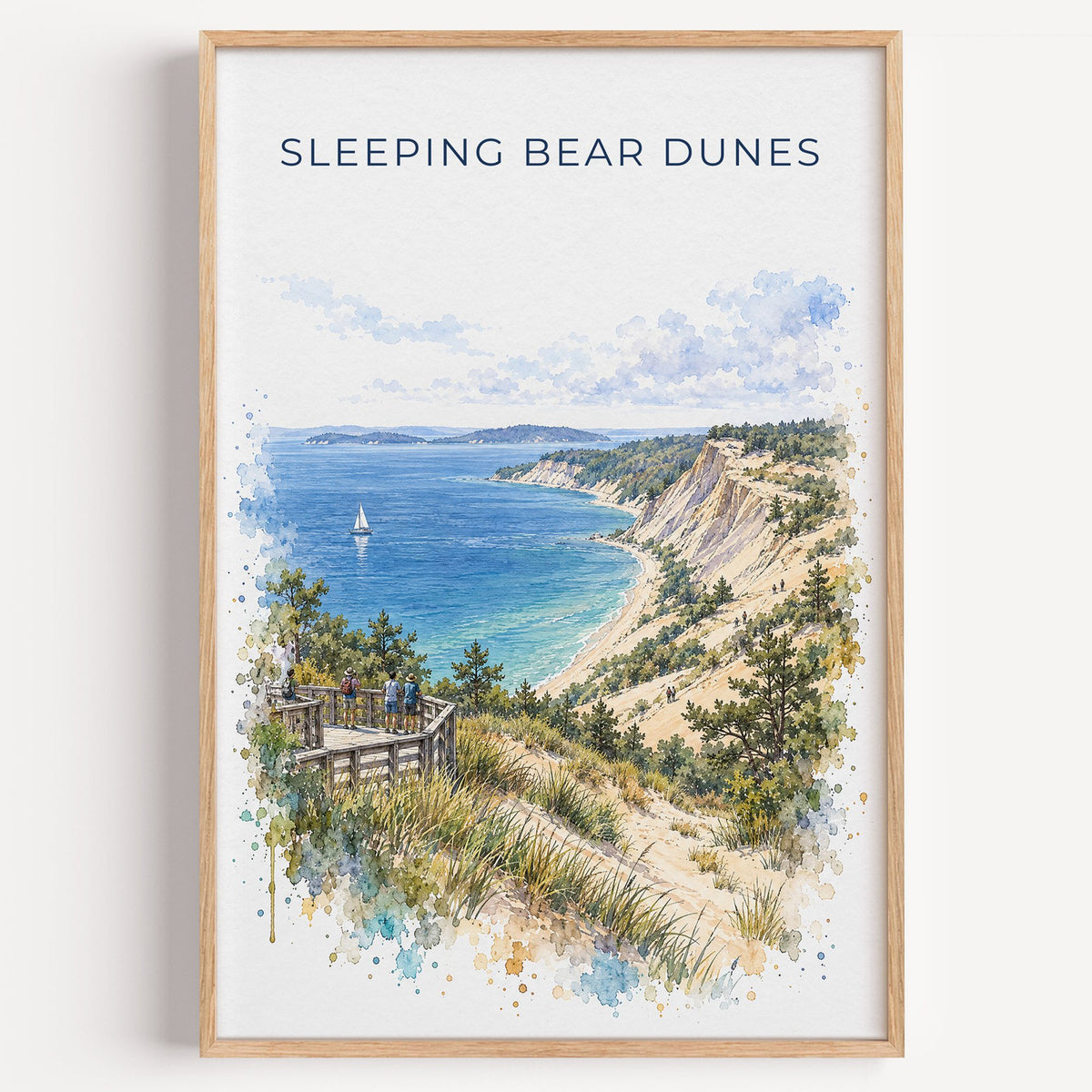 Sleeping Bear Dunes watercolor print in a light oak frame on a plain white wall