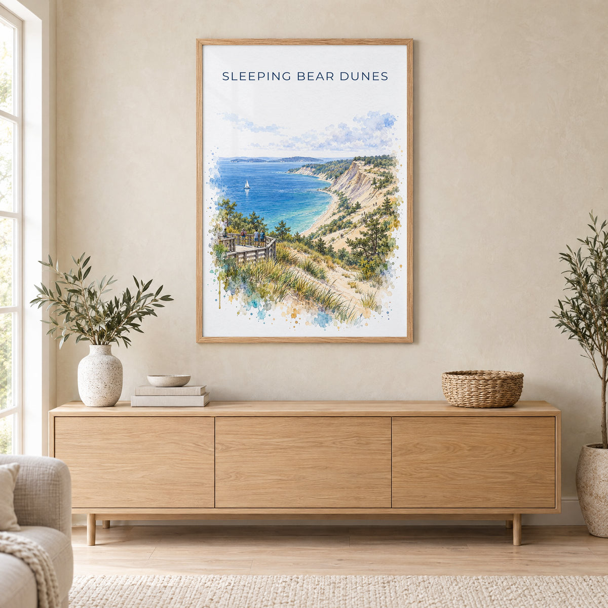 Sleeping Bear Dunes watercolor print in an oak frame above a light wood sideboard in a Scandinavian living room